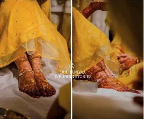 Bride's mehendi-covered feet and hands in a yellow lehenga during the haldi